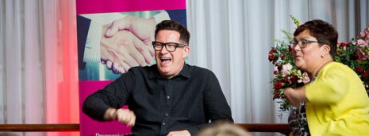 helga henry and matthew bourne, seated and laughing